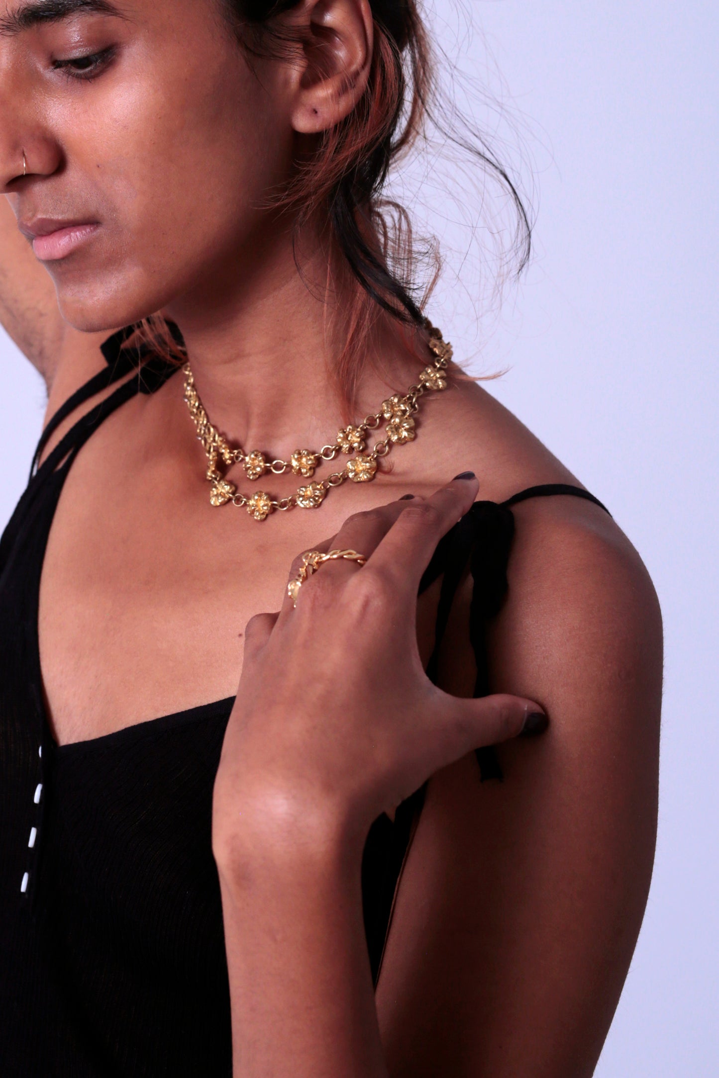 Model wearing CLARK Necklace, this stunning statement piece is a perfect keepsake for an occasion, a wedding or a celebration. Paired with the CLARK Rosary Earrings, they become a beautiful coordinated set. The half moon shape of flower chain links can be seen on her collarbone.