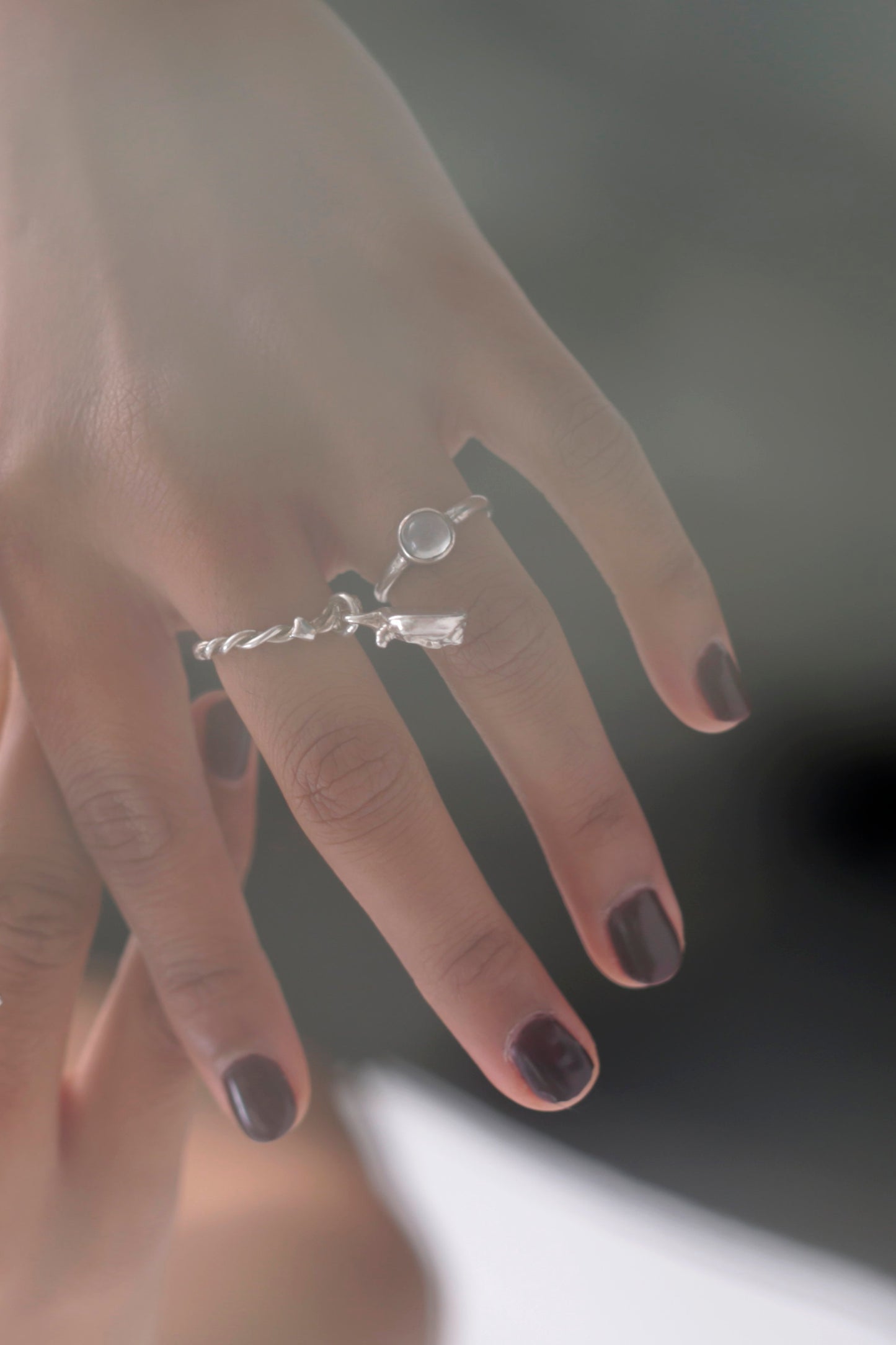 Model hand wearing the Magic Moonstone Ring by CLARK and the Lilith Ring by CLARK. Photo clearly shows an ethereal iridescent moonstone gem. This is a mystical statement gift.