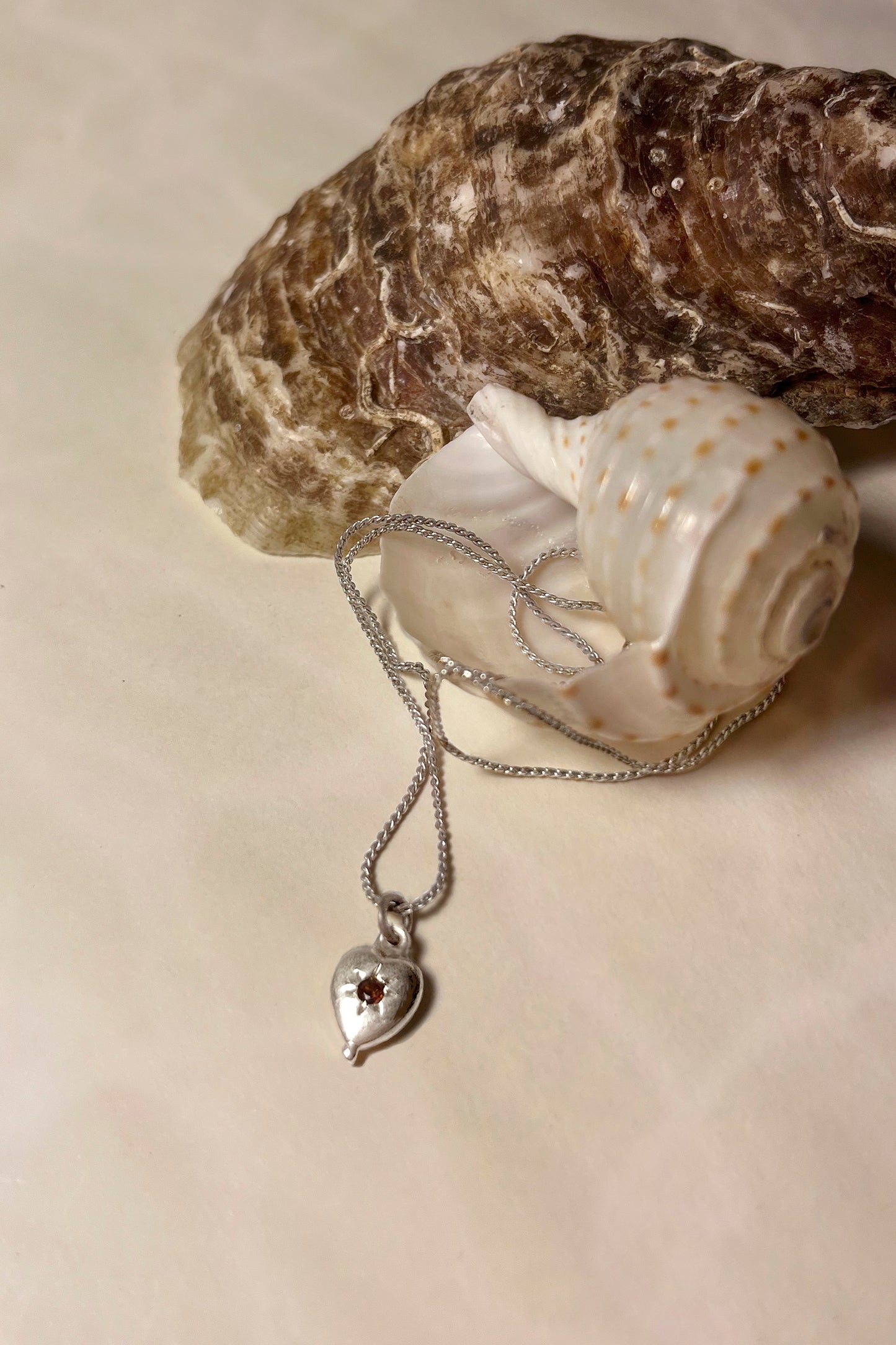 Underwater scene of Sterling Silver CLARK Tiny Heart Charm Necklace. Perfect luxury gift for a loved one, wedding or anniversary 