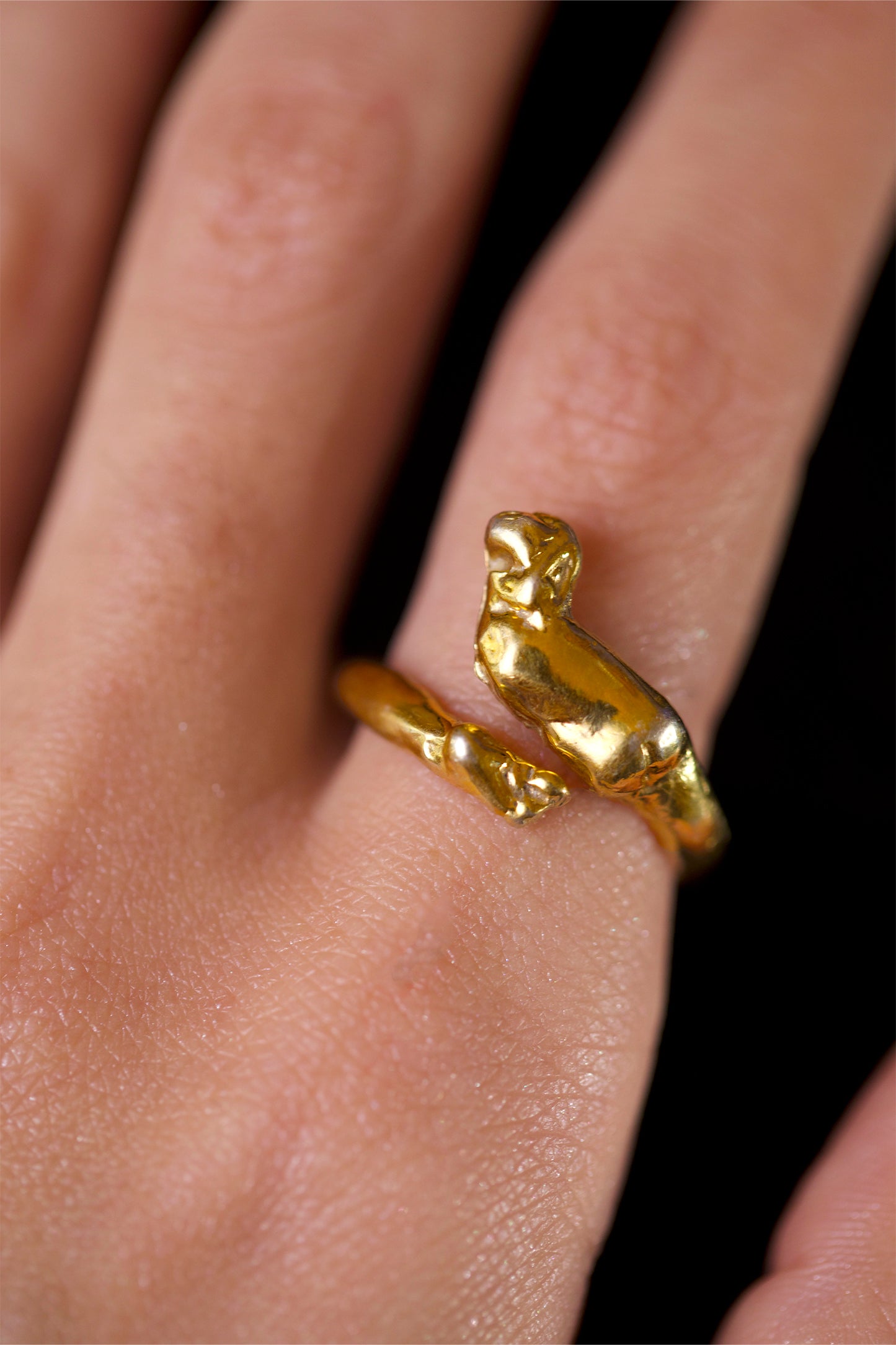 Model wearing Cupid Ring by CLARK in 18K Gold Vermeil on her index finger. The ring is adjustable and wrapped around the finger with ease. This romantic ring is a perfect gift for an anniversary or wedding. 