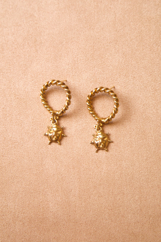 Ouroboros Sun Drop Earring by CLARK. These earrings feature a twisted loop with a small sun-faced charm. Symbolic of rebirth and hand made in 18K Gold Vermeil - a brilliant gift to complete any collection.