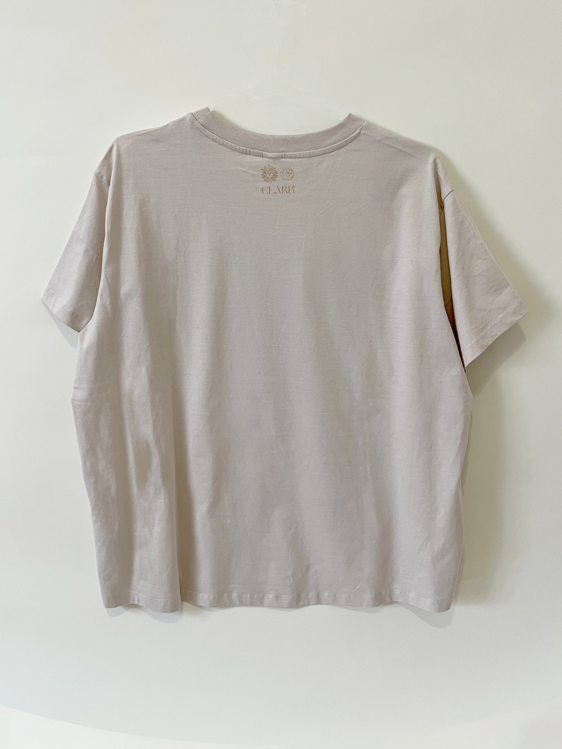Product photo of Happy As A Clam tee by CLARK. The Back view of straight-cut gray tee with CLARK logo printed in gold at neck. Logo is of Sun and Moon with CLARK underneath. 