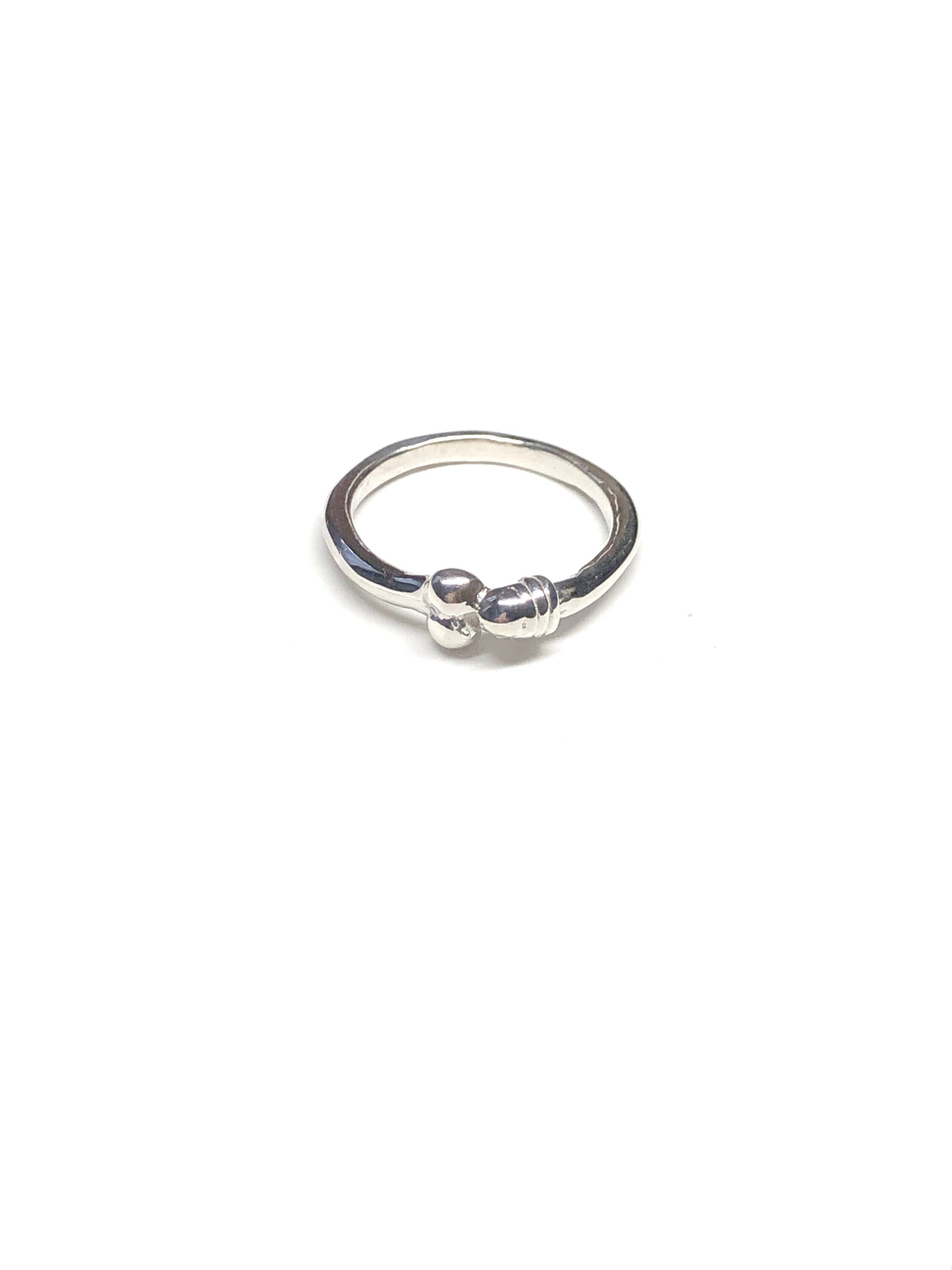 Product photo of Eros Ring by CLARK in high-polished, high-quality Sterling Silver. This discreet design embodies an enigmatic yearning and adoration. Each ring is meticulously handcrafted, using the lost wax casting technique 