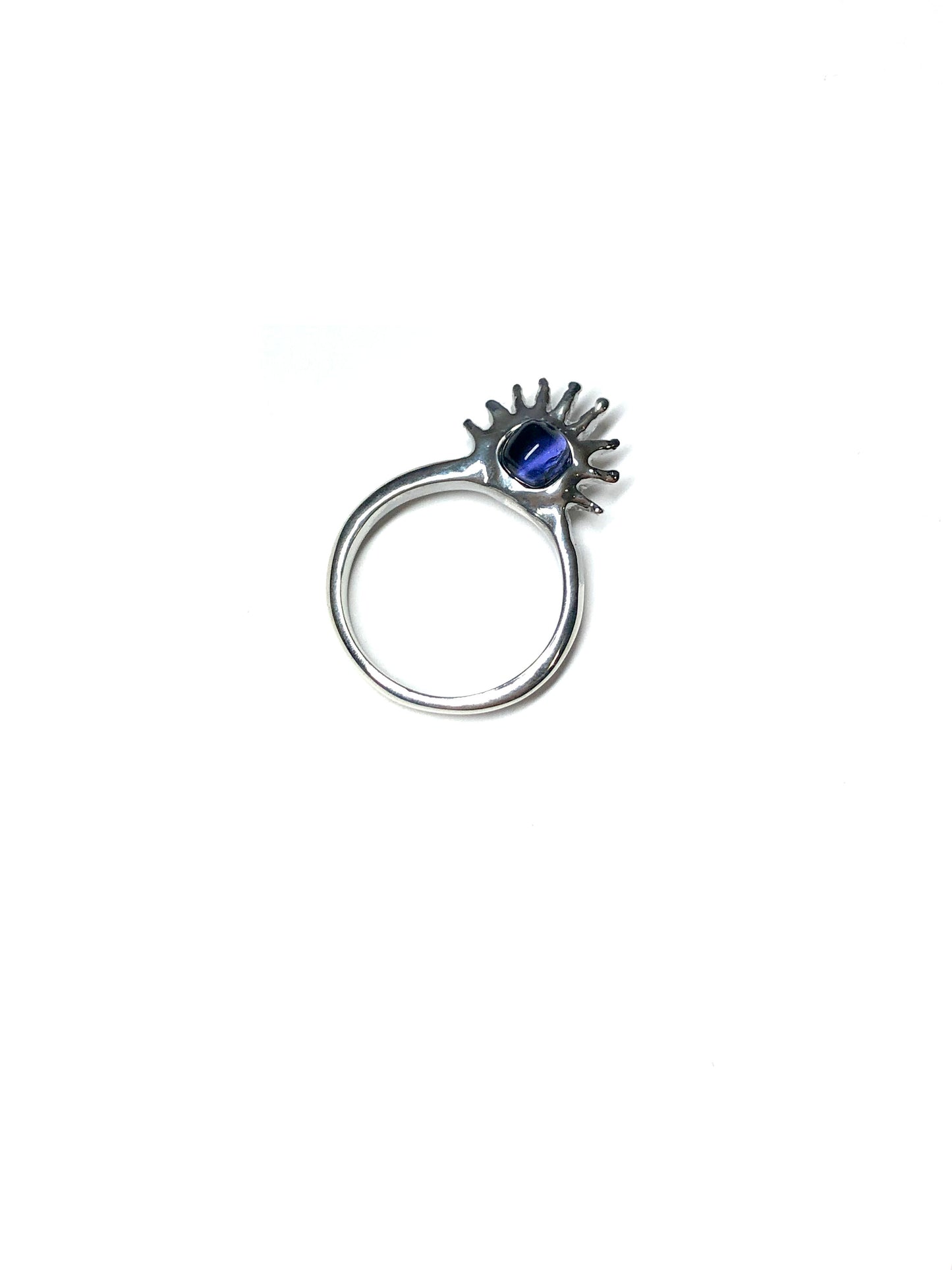 Sol Ring by CLARK in Sterling Silver. This one-of-a-kind hand craft item features a purple gemstone set with high quality metal sun rays laid on white ground. This is a unique ring, a gift for occasion or everyday wear. 